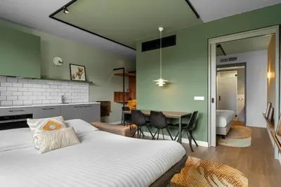 a bedroom with a bed and a dining room at Residence Inn by Marriott Amsterdam Schiphol Airport in Badhoevedorp