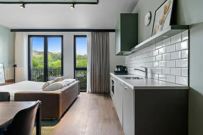 a kitchen and living room with a couch and a table at Residence Inn by Marriott Amsterdam Schiphol Airport in Badhoevedorp