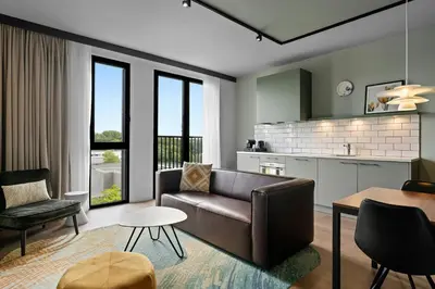 a living room with a couch and a table at Residence Inn by Marriott Amsterdam Schiphol Airport in Badhoevedorp