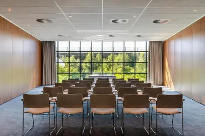 a conference room with a table and chairs at Residence Inn by Marriott Amsterdam Schiphol Airport in Badhoevedorp