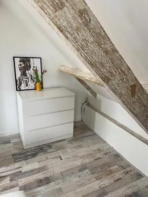 a stairwell with a white dresser in a room at zilvermeeuw in Bergen aan Zee