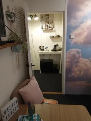 a room with a door with a painting of clouds at B&Bslapenopeeneiland in Kaag
