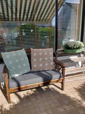 a wooden bench sitting on a porch at B&Bslapenopeeneiland in Kaag