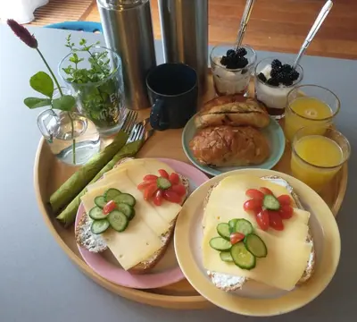 a plate of food with sandwiches and vegetables on a table at B&Bslapenopeeneiland in Kaag