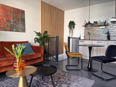 a living room with a couch and a table at Strand en meer in Katwijk aan Zee