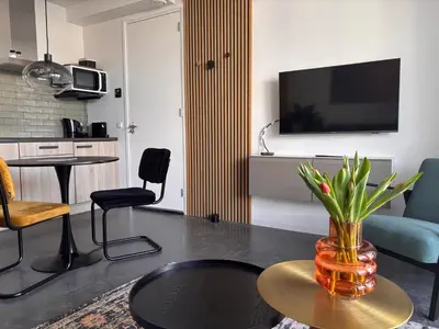 a living room with a vase on a table at Strand en meer in Katwijk aan Zee