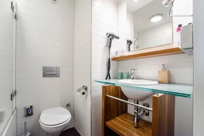 a bathroom with a sink and a toilet at Suite with stunning sea view in Zandvoort
