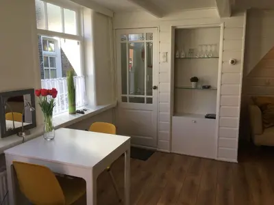 a room with a white door and a table and chairs at Family fisherman's house Volendam in Volendam
