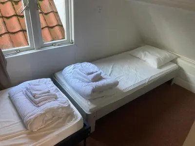 two beds sitting in a room with a window at Family fisherman's house Volendam in Volendam