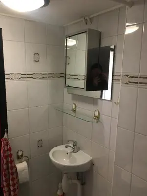 a person taking a picture of a bathroom with a sink at Family fisherman's house Volendam in Volendam