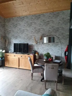 a living room with a table and a tv at Tjotter in Amsterdam