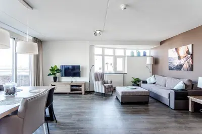 a living room with a couch and a table at Kaag Resort in Warmond