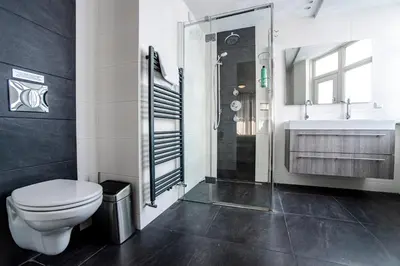 a bathroom with a toilet and a sink and a shower at Kaag Resort in Warmond