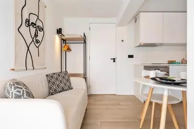 a living room with a couch and a table at Studio Thor, With free parking in Zandvoort