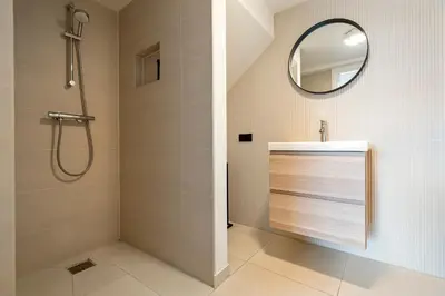 a bathroom with a shower and a mirror at Studio Thor, With free parking in Zandvoort