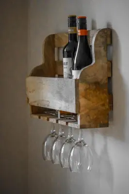 a wine rack with wine bottles and wine glasses at De Kroft Beach Residences Noordwijk aan Zee in Noordwijk