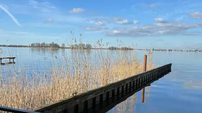 a dock in the middle of a large body of water at Plassenzicht Logies & Sloepverhuur in Loosdrecht