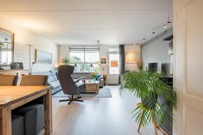 a living room with a couch and a table at De Zonnestraal in Bergen