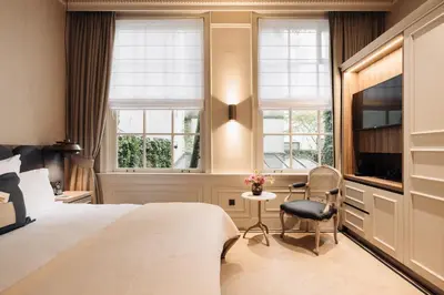 a hotel room with a bed and a desk and a tv at Hotel 717 in Amsterdam