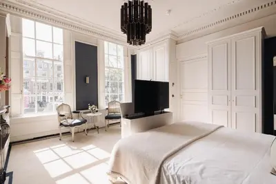 a bedroom with a bed and a tv and a table at Hotel 717 in Amsterdam