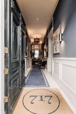 a hallway with a door with a rug on it at Hotel 717 in Amsterdam