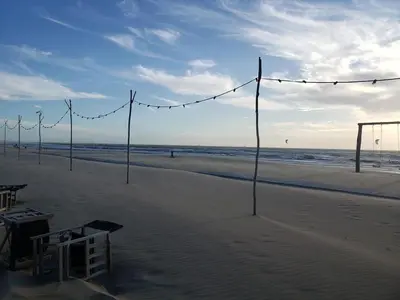 a beach with volleyball nets and lights on the beach at Zeelicht in Noordwijkerhout
