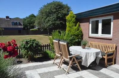 a patio with a table and two chairs and a table and a table and chairs at Zeelicht in Noordwijkerhout