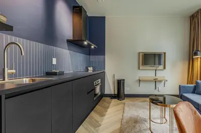 a kitchen with a sink and a blue wall at Bens The Highdocks in Amsterdam