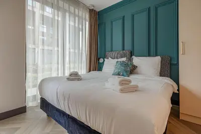a bedroom with a large bed with towels on it at Bens The Highdocks in Amsterdam