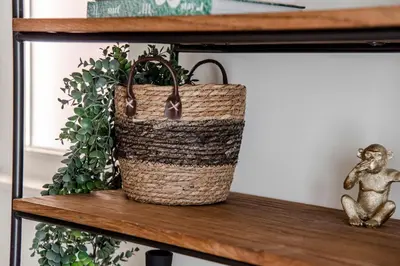 a basket sitting on a shelf with a plant at Marley’s Beachhouse - Luxury Apartment with garden in Zandvoort