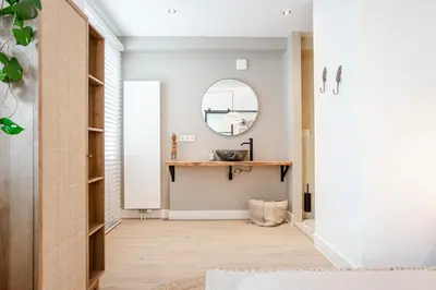a hallway with a mirror and a table at Marley’s Beachhouse - Luxury Apartment with garden in Zandvoort