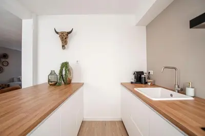 a kitchen with a counter top and a sink at Marley’s Beachhouse - Luxury Apartment with garden in Zandvoort