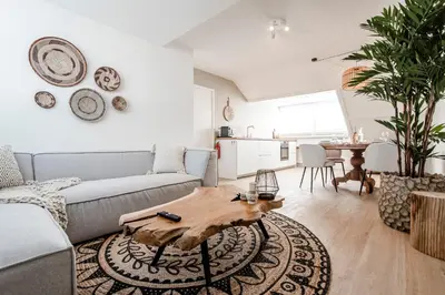 a living room with a couch and a table at Yucca Beachhouse in Zandvoort