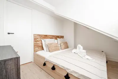 a bedroom with a bed with a brick wall at Yucca Beachhouse in Zandvoort