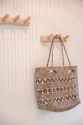 a tote bag hanging on a wall next to a radiator at Yucca Beachhouse in Zandvoort