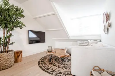 a living room with a white couch and a table at Yucca Beachhouse in Zandvoort