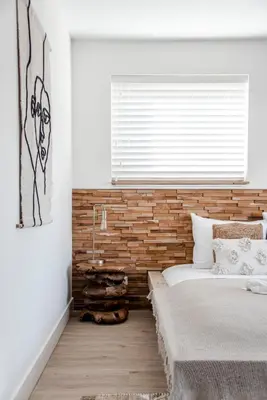 a bedroom with a bed and a brick wall at Marley’s Beachhouse - Luxury Guest Room with balcony in Zandvoort