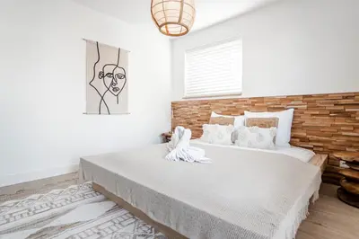 a bedroom with a large bed with a brick wall at Marley’s Beachhouse - Luxury Guest Room with balcony in Zandvoort