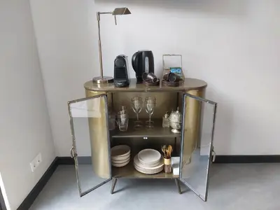 a shelf with plates and glasses and a lamp at Saya Boutique Hotel in Amersfoort