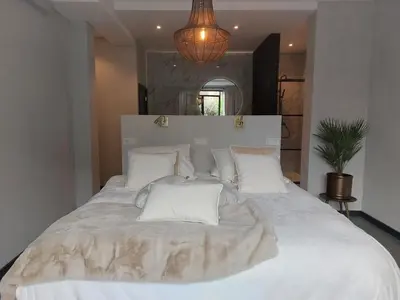 a large bed with white sheets and pillows at Saya Boutique Hotel in Amersfoort