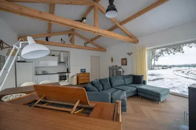 a living room with a couch and a table at Beautiful Countryside house, close to Amsterdam in Broek in Waterland