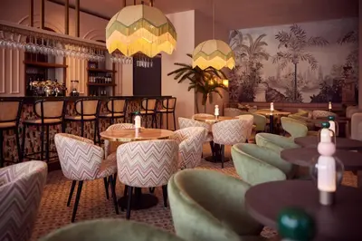 a restaurant with tables and chairs and a bar at Van der Valk Hotel Lelystad in Lelystad