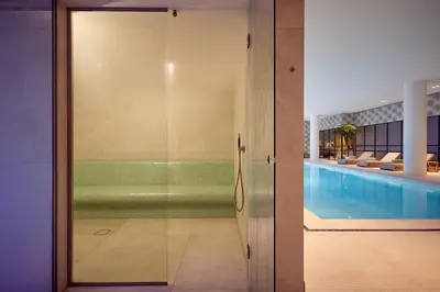 a glass door leading to a swimming pool at Van der Valk Hotel Lelystad in Lelystad