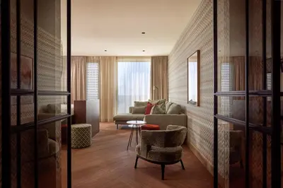 a living room with a couch and a chair at Van der Valk Hotel Lelystad in Lelystad