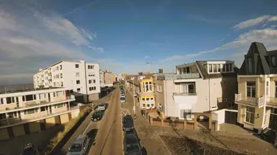 a view of a city street with buildings and cars at Studio Tara at the Beach with Private Parking in Zandvoort