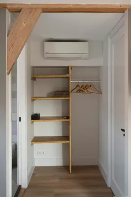 a room with a closet with a fan at The Lake Inn in Nieuwkoop