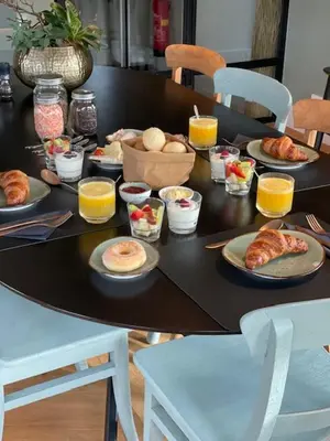 a black table with plates of food and orange juice at The Lake Inn in Nieuwkoop