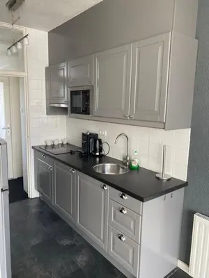 a kitchen with a sink and a microwave at De Wulk 27 in Zandvoort