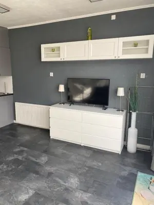 a living room with a flat screen tv on a wall at De Wulk 27 in Zandvoort