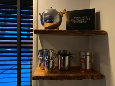 a shelf with cups and a teapot on it at Holidayhome Geuzenhoeve op de Munnickaij in Schellinkhout